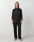 The Scholar Jacket, black side, front view with mandarin collar and knotted closures