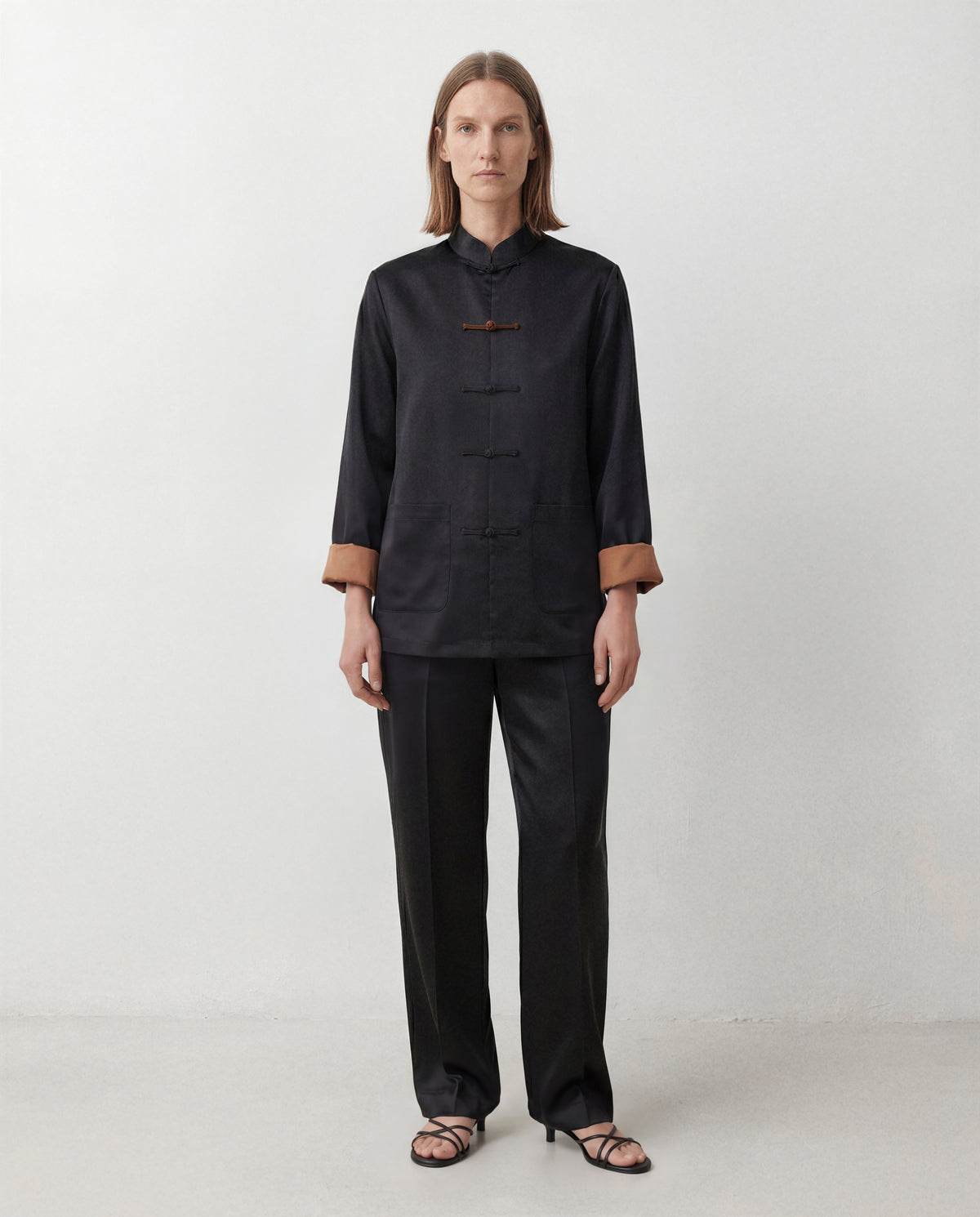 The Scholar Jacket, black side, front view with mandarin collar and knotted closures